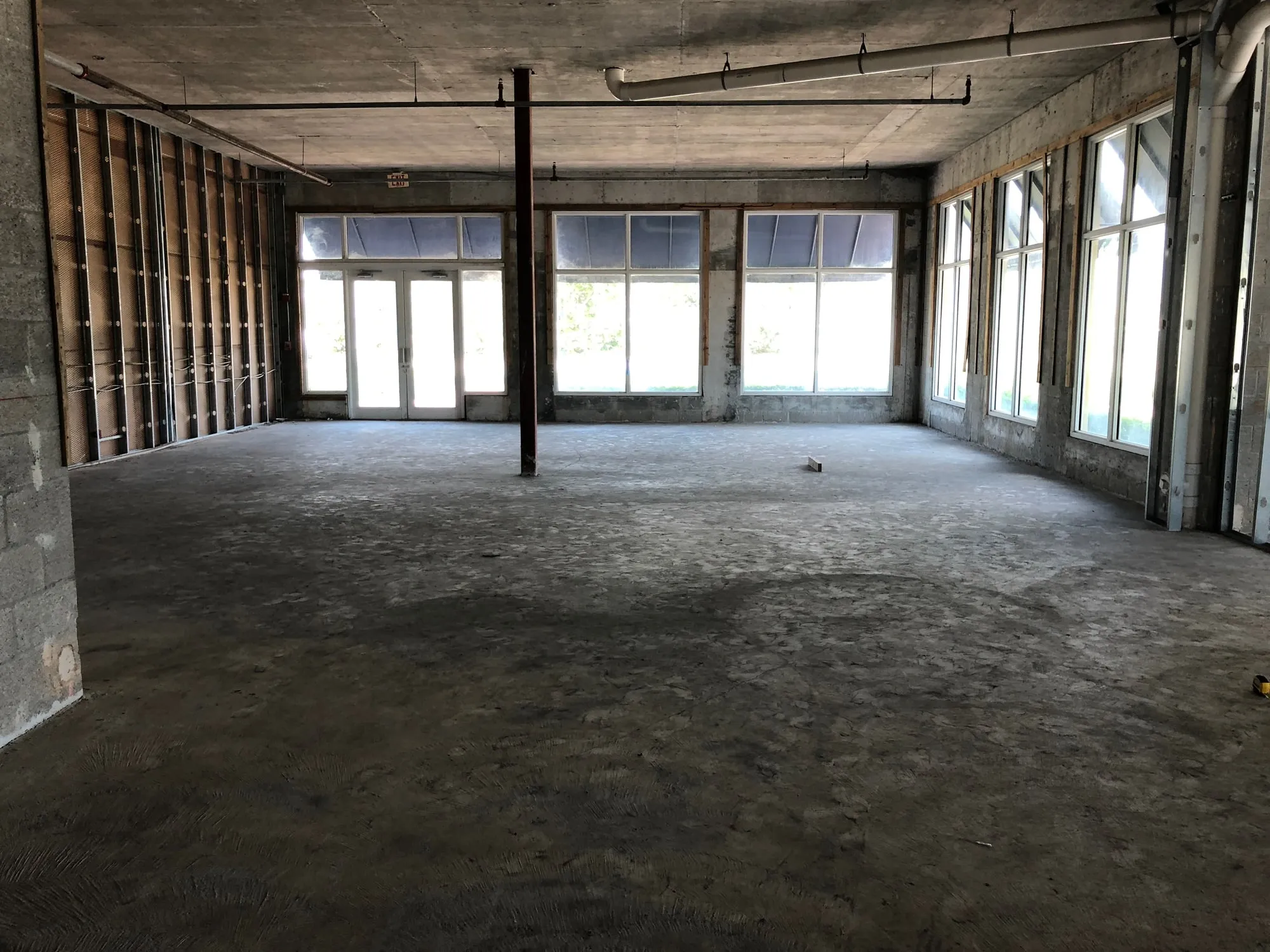 Commercial storefront space stripped back to the slab before buildout
