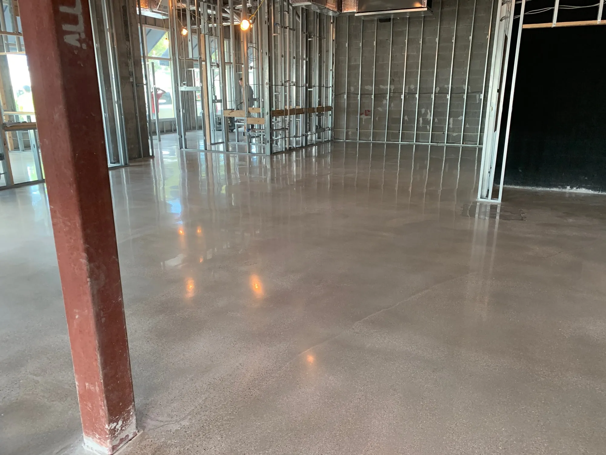 Polished concrete floor finished across a commercial retail space
