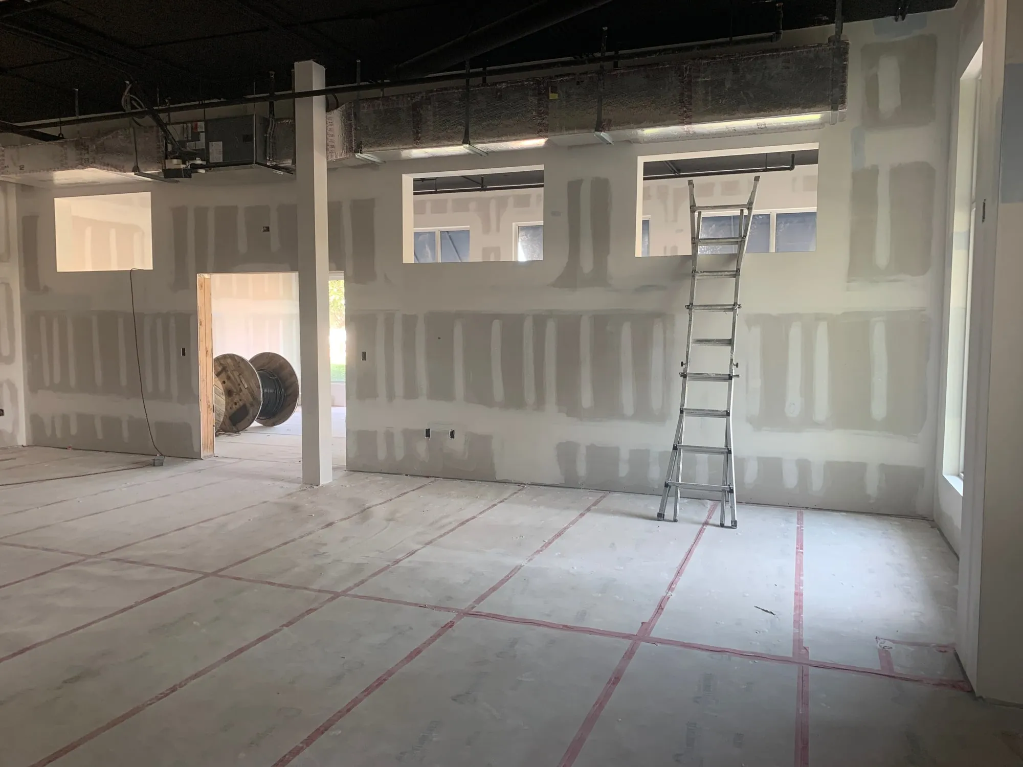 Drywall installation underway in a commercial interior
