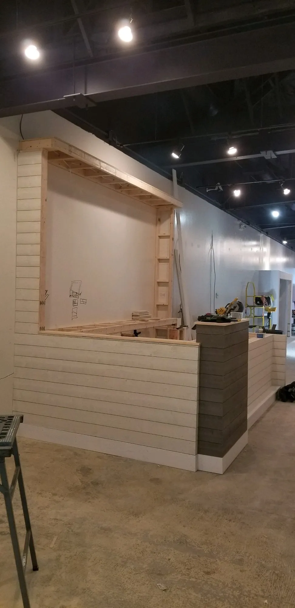 Framed stair landing and platform inside a retail buildout