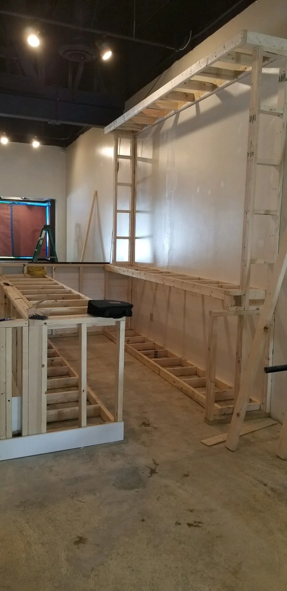 Steel stud partitions framing out fitting rooms in a retail space
