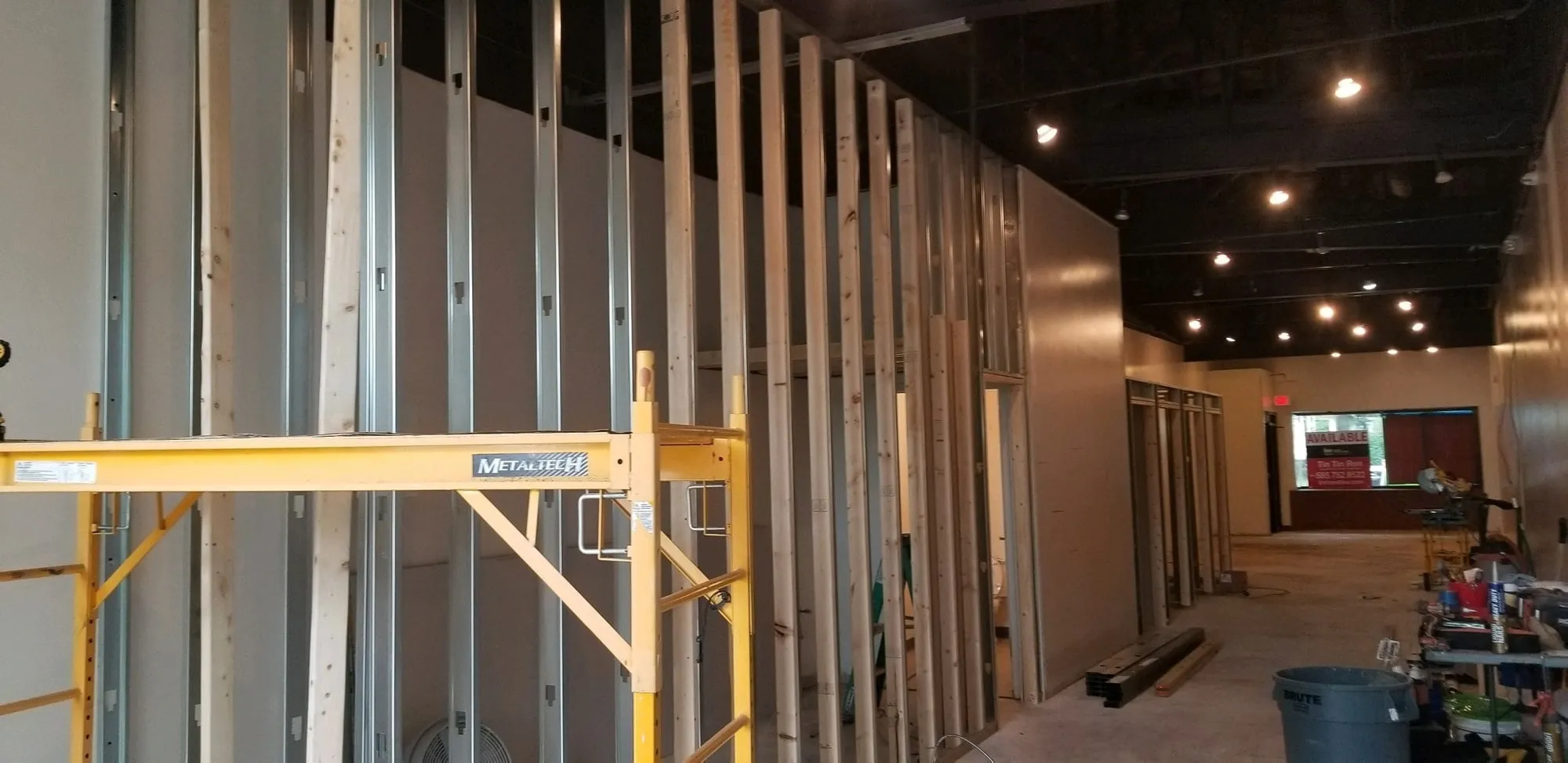 Commercial partition framing with drywall being hung
