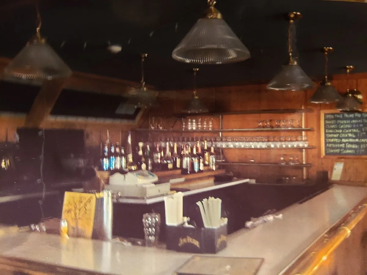 Restaurant bar with pendant lights and glassware shelving
