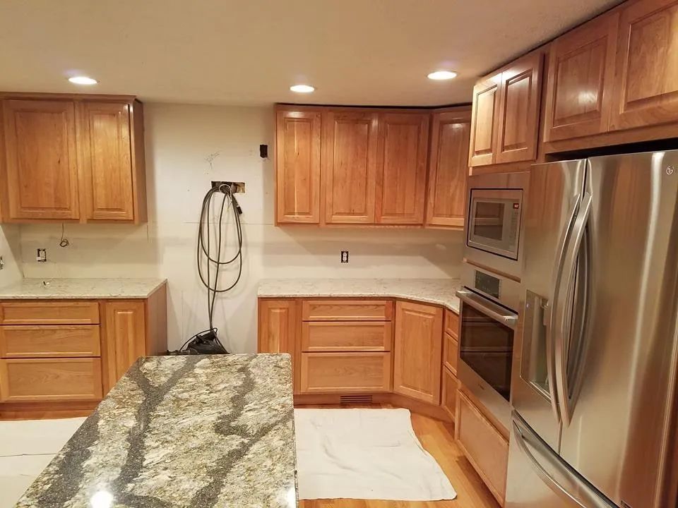 Remodeled kitchen with cherry cabinets, granite countertops and a stainless steel wall oven
