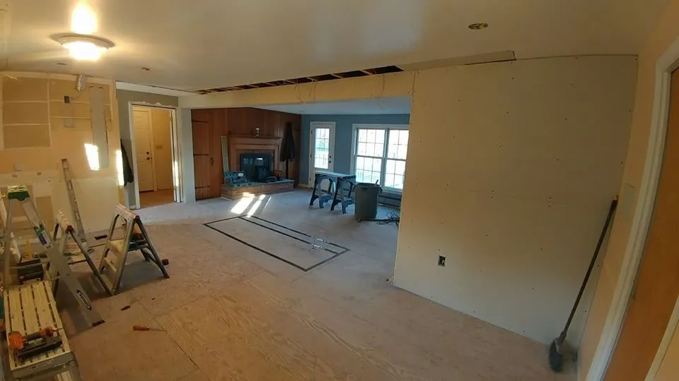 Open living space after a load-bearing wall removal, ready for finishing
