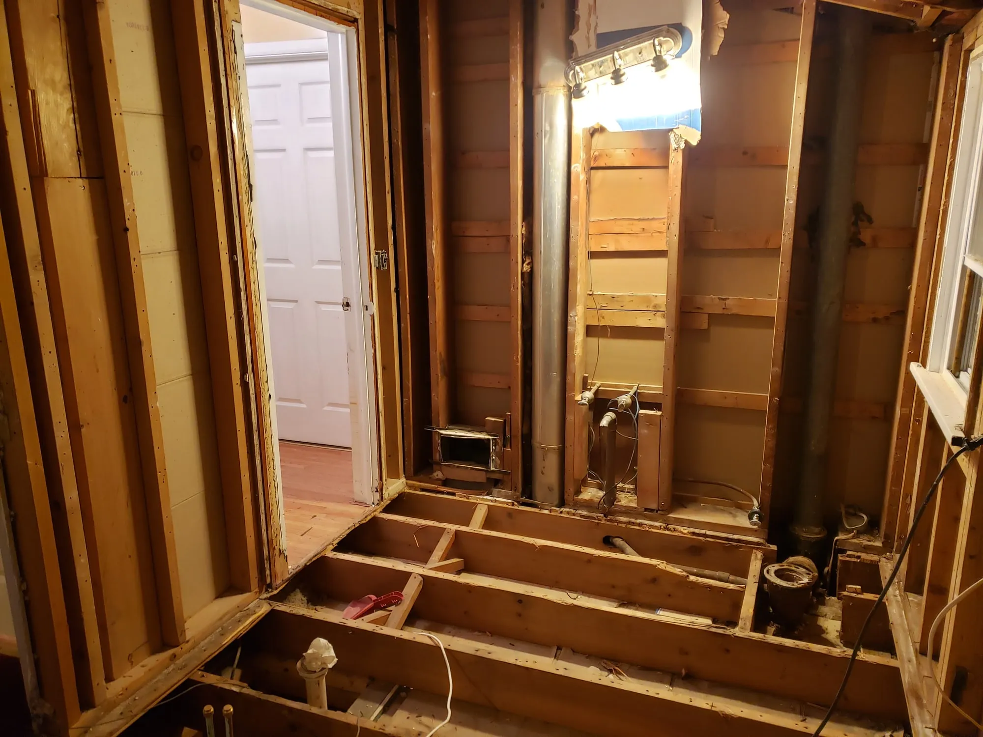 Bathroom stripped to the studs at the start of a full remodel
