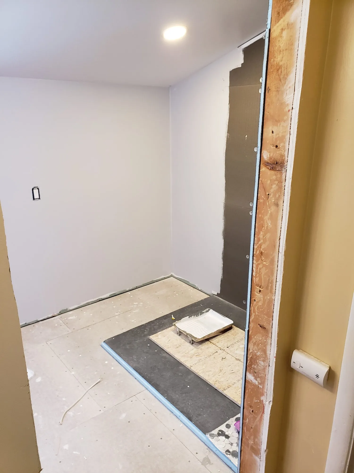Bathroom floor prepared for a curbed shower pan installation