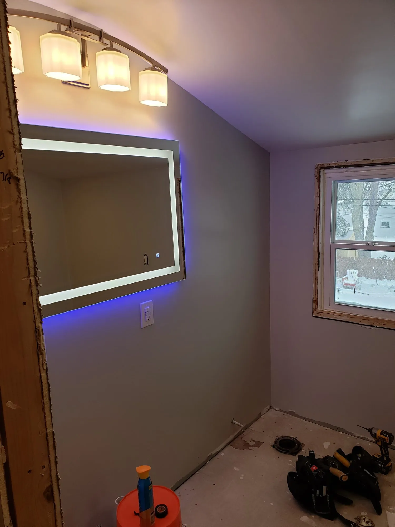 New bathroom with a backlit LED mirror installed above the vanity