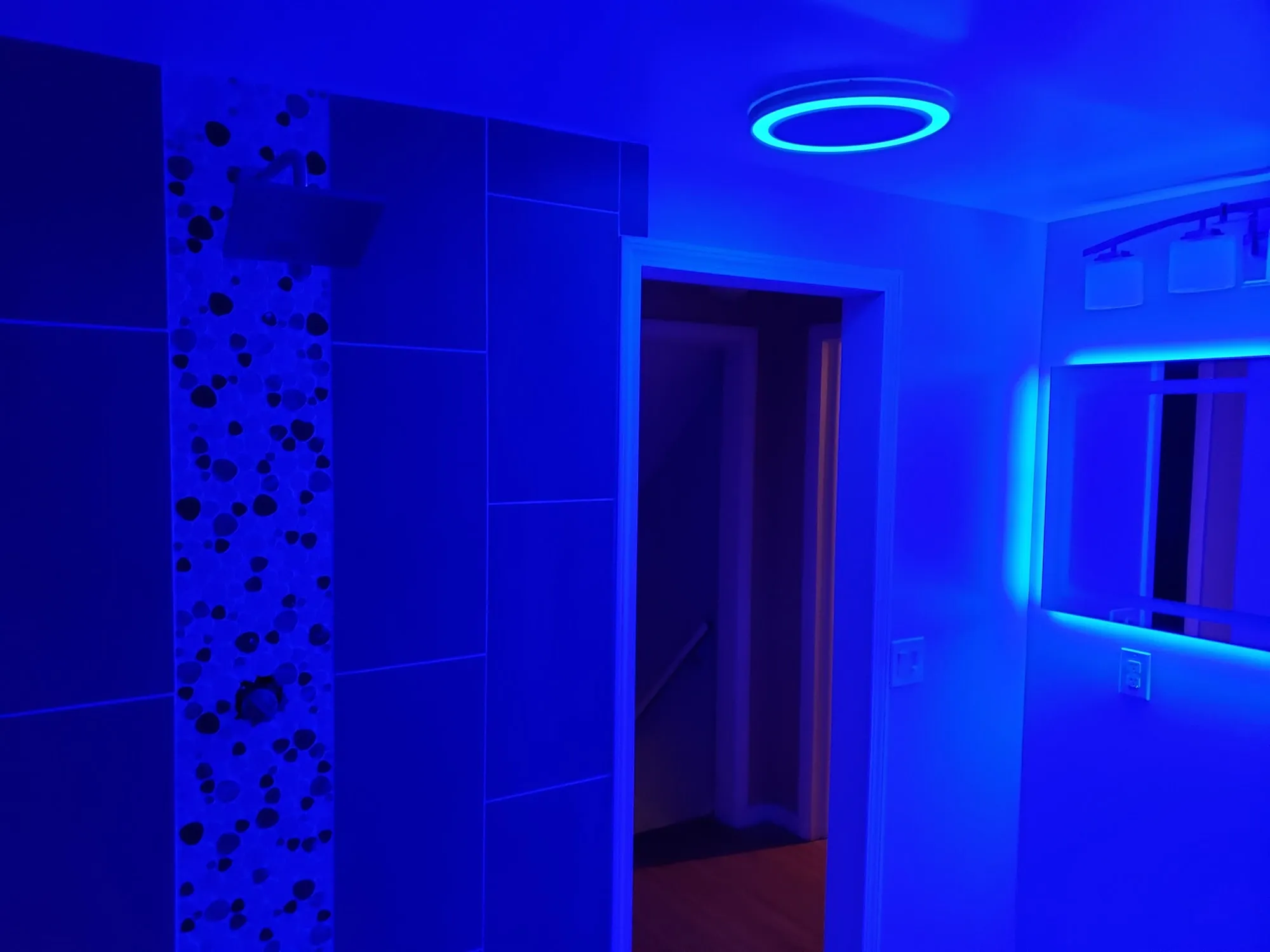 Completed marble-look vanity counter and tiled shower entry